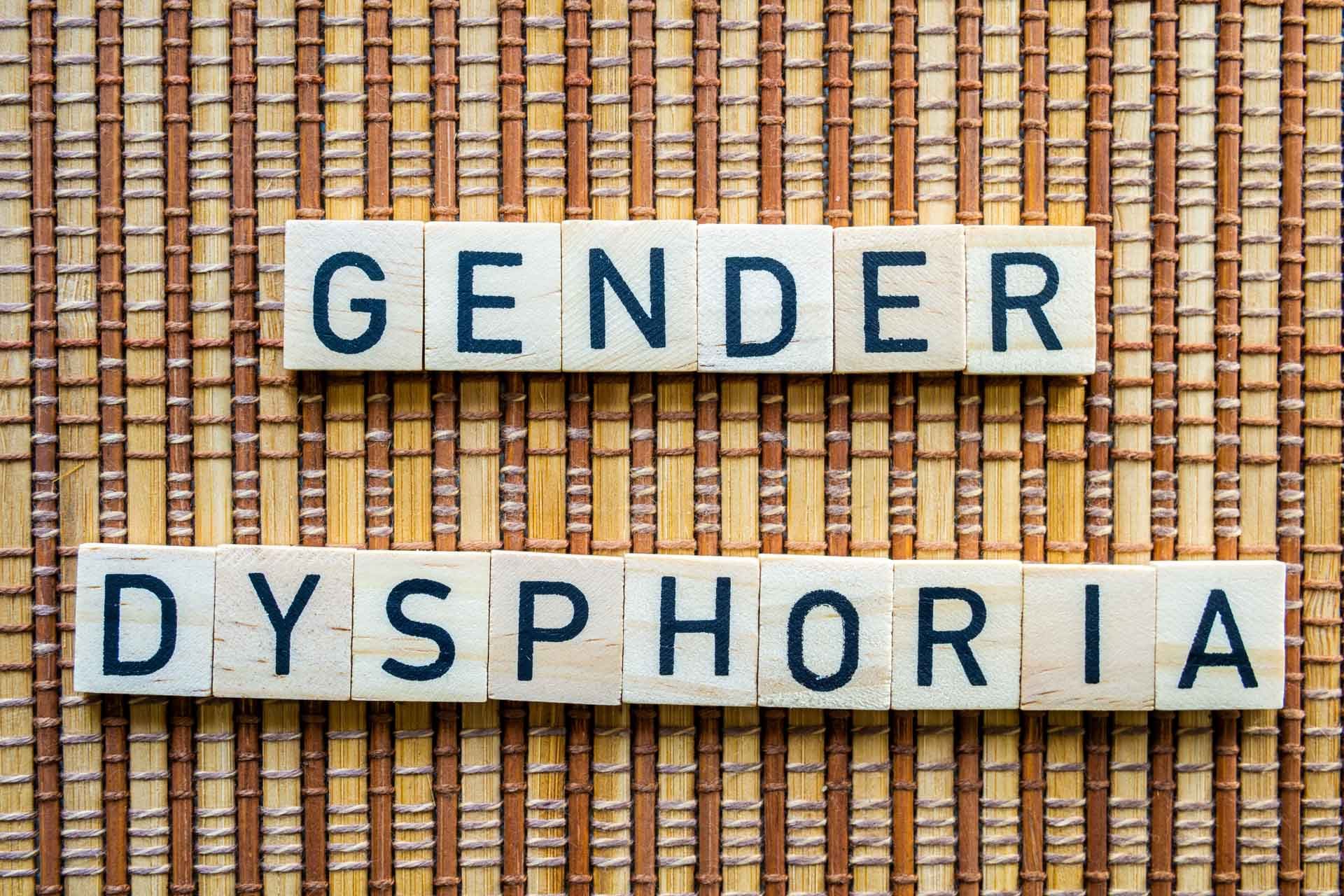 Gender,Dysphoria,Concept,Word,In,Wooden,Letters,On,Straw,Mat