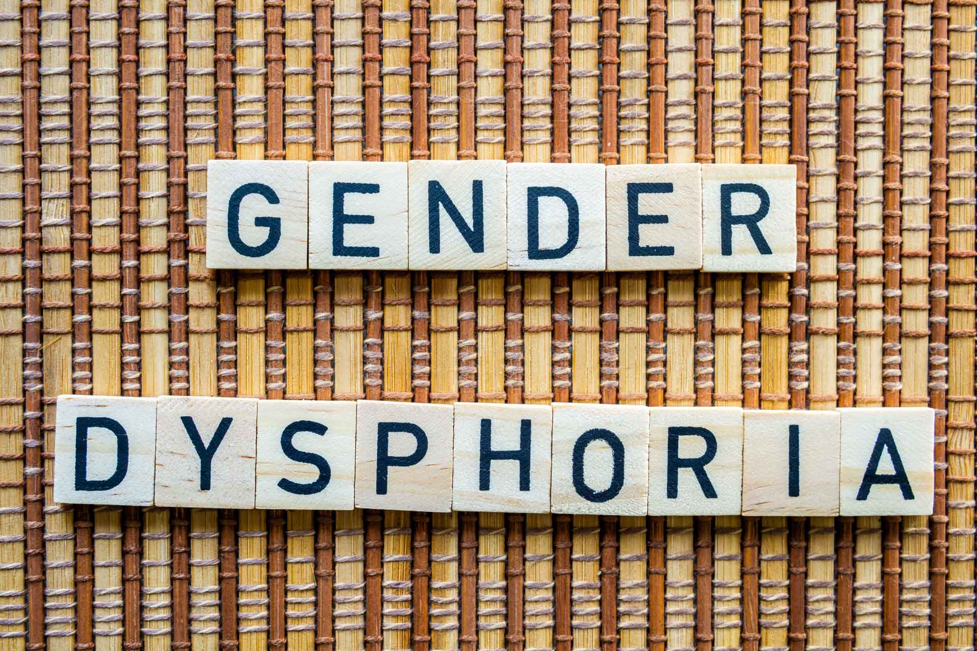 Gender,Dysphoria,Concept,Word,In,Wooden,Letters,On,Straw,Mat