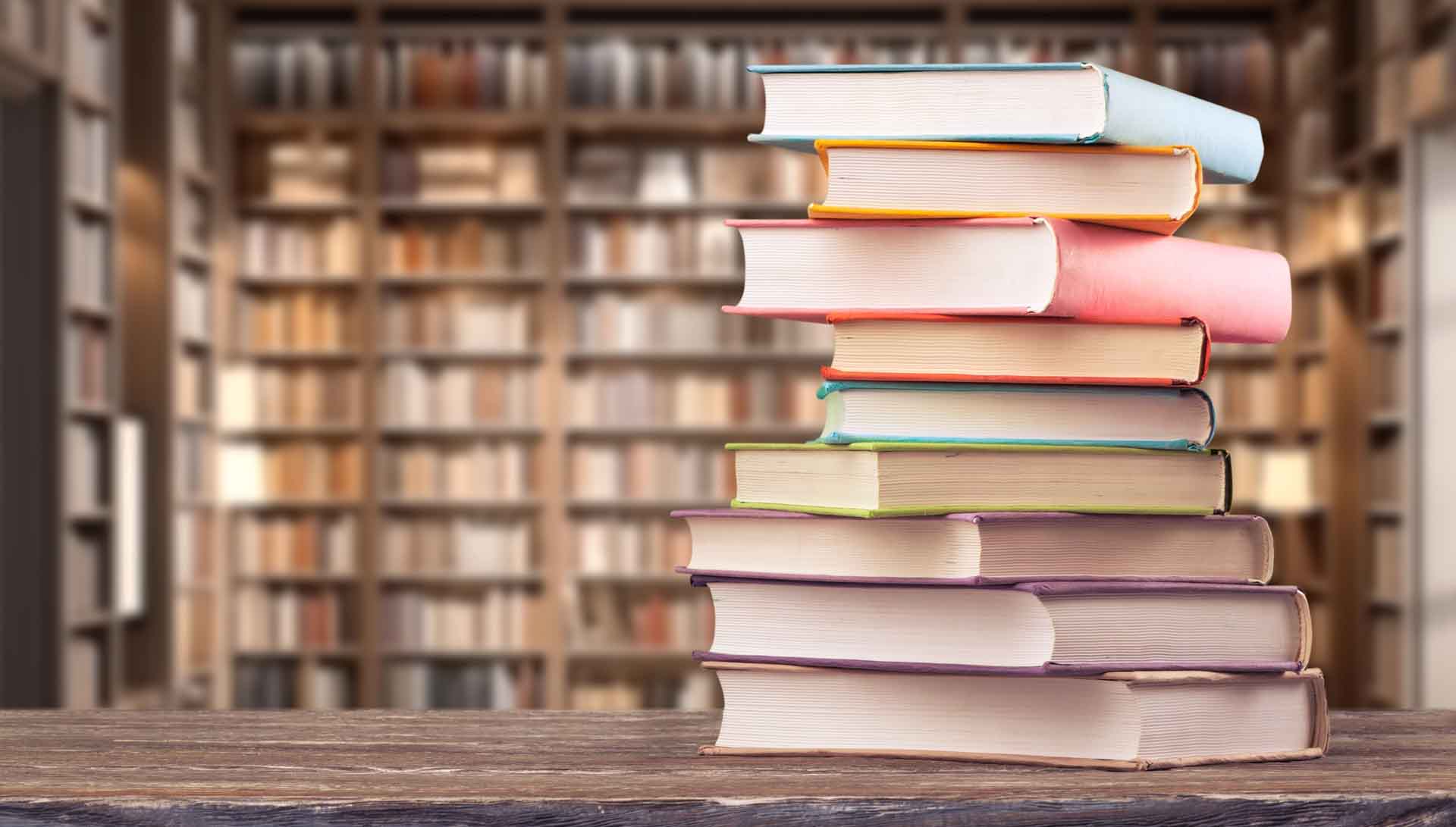 Book,Stack,On,The,Desk,In,Public,Library