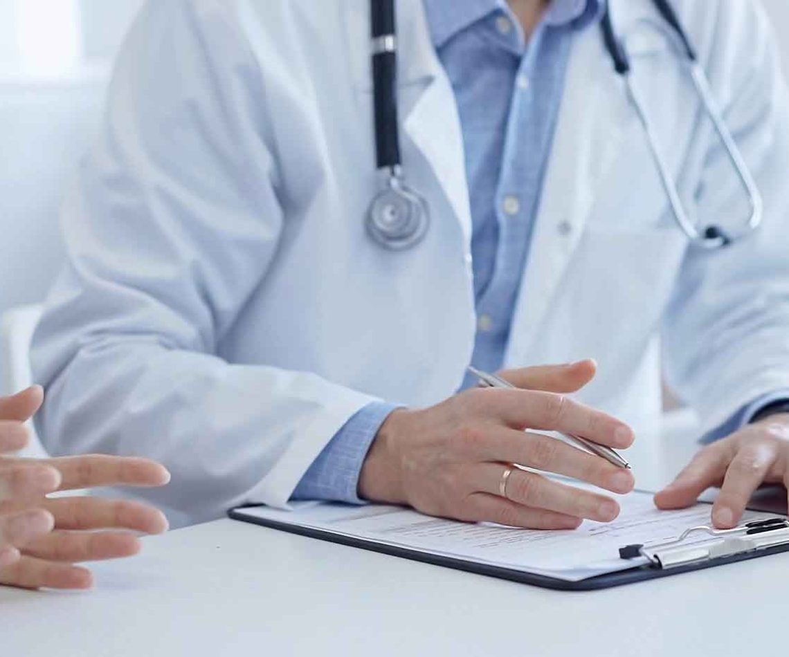 A,Doctor,And,A,Patient.,The,Physician,,Wearing,A,White