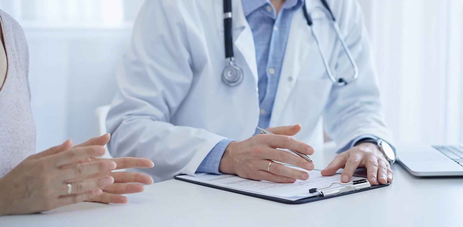 A,Doctor,And,A,Patient.,The,Physician,,Wearing,A,White